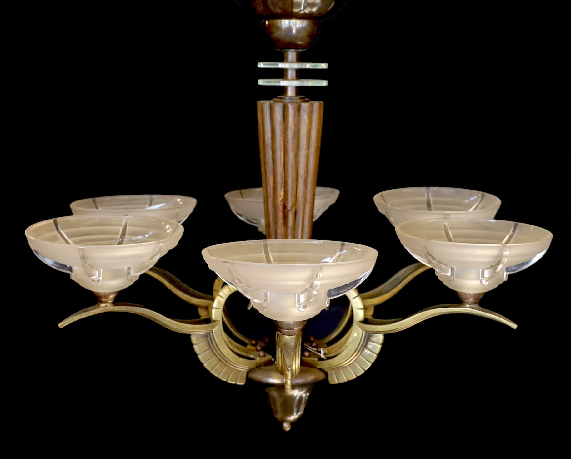A French Art Deco bronze, hardwood and frosted glass six light chandelier, in the manner of Henri Petitot, height 64cm. width 74cm